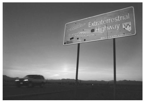 A car moves along the Extraterrestrial Highway, a roadway that runs along the eastern border of Area 51, a military base on the Nevada test site that the U.S. government has only recently admitted "officially" exists. AP/WIDE WORLD PHOTOS.