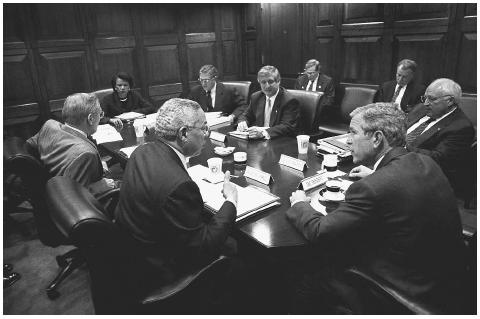 President Bush meets with his National Security Council in the White House situation room in October, 2001. Clockwise, from center are: White House Chief of Staff Andrew Card, Vice president Dick Cheney, President Bush, Secretary of State Colin Powell, Defense Secretary Donald Rumsfeld, and National Security Advisor Condoleeza Rice. AP/WIDE WORLD PHOTOS.