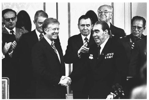 United States President Jimmy Carter, left center, and Soviet President Leonid Brezhnev, right center, shake hands amidst applause in the Vienna Imperial Hofburg Palace after signing the SALT II treaty, June 8, 1979. AP/WIDE WORLD PHOTOS.