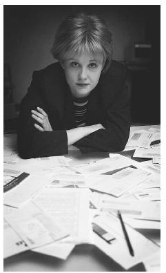 Associated Press reporter Nedra Pickler displays the unauthorized credit card bills charged to her name in 2002 after she became the victim of identity theft, a growing crime. In a matter of a week, thieves charged $30,000 worth of merchandise on credit cards obtained using her identity. AP/WIDE WORLD PHOTOS.