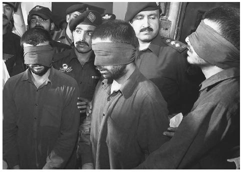 Three blindfolded men accused of working for India's intelligence agency and plotting to sabotage Pakistan's 2002 parliamentary elections are presented to the press in Rawalpindi, Pakistan. AP/WIDE WORLD PHOTOS.