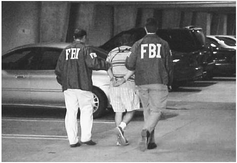A U.S. college student is arrested by FBI agents in Los Angeles, California, for the perpetration of an Internet hoax in 2000, in which he made over $241,000 and lost a Southern California high-tech company billions of dollars in market value. ©AFP/CORBIS.