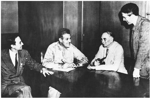Brigadier General Leslie Groves (second from left), shown in conversation with Manhattan project scientists Sir James Chadwick (left), Dr. Richard Tolman (second from right), and Dr. H. D. Smyth. © HULTON-DEUTSCH COLLECTION/CORBIS.