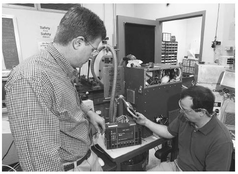 Researchers at the Oak Ridge National Laboratory in Oak Ridge, Tennessee, test a portable chemical and biological agent monitor developed for the army and marines in 2001. AP/WIDE WORLD PHOTOS.