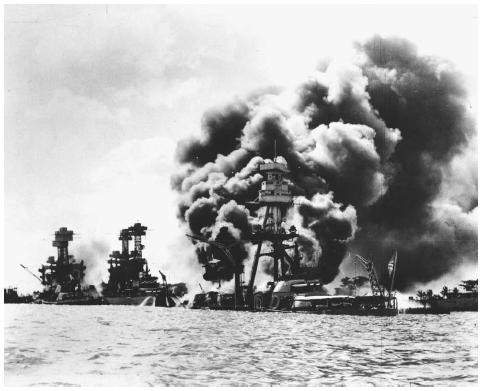 Three U.S. battleships are hit from the air during the Japanese attack on Pearl Harbor on December 7, 1941. From left are: USS West Virginia, severly damaged; USS Tennessee, damaged; and USS Arizona, sunk. AP/WIDE WORLD PHOTOS.