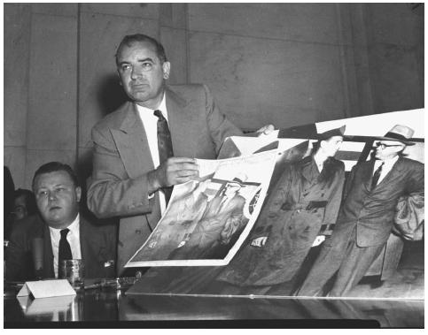 Senator Joseph McCarthy answering charges that the photo, foreground, submitted as an exhibit at Army dispute hearings in 1954, had been altered. AP/WIDE WORLD PHOTOS.