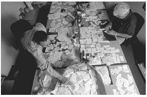 Workers shown in this 1998 photo reconstituting the Stasi archives which were torn up and put into 17,000 bags. ©BOSSU REGIS/CORBIS SYGMA.