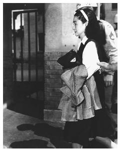 Iva Toguri D'Aquino, also known as Tokyo Rose, on her way to court in San Francisco, California in 1949, where she was on trial for treason and broadcasting propaganda to Allied troops during World War II. AP/WIDE WORLD PHOTOS.