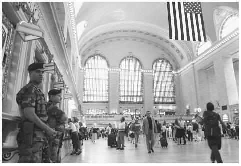 United States soldiers, left, stand watch in Grand Central Terminal in New York after the Transportation Department warned transit and other railroad systems about possible terrorist attacks in May 2002. AP/WIDE WORLD PHOTOS.