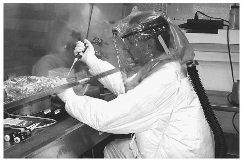 A research scientist processes anthrax samples that are thought to contain a significant aerosol and respiratory hazard. AP/WIDE WORLD PHOTOS.