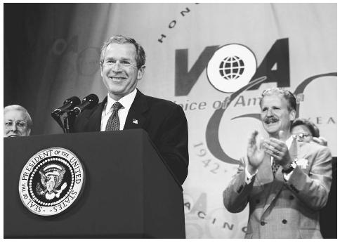President Bush marks the 60th anniversary of Voice of America, a service that relays news to the world in 53 languages by radio, TV, and the Internet, at a celebration at VOA headquarters in Washington, D.C., in February 2002. AP/WIDE WORLD PHOTOS.