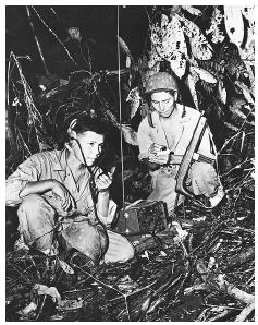 A two-man team of Navajo code talkers attached to a marine regiment in the Pacific relay orders over the field radio using their native Navajo language, a particularly effective code used during World War II. ©CORBIS.
