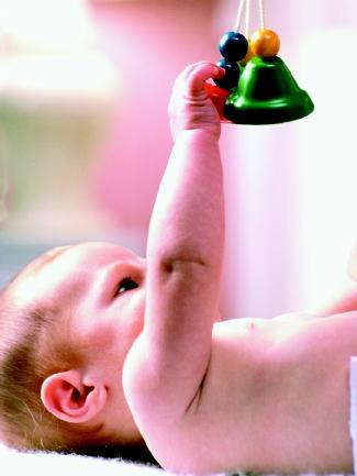 An infant tests his depth perception. Depth perception—including how the mind sees in three dimensions though the retina on which the image is registered is flat—appears to be related to binocular vision. (Photograph by Gabe Palmer. Reproduced by permission of The Stock Market.)