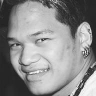 A young  man shows off his multiple ear piercings. (Photograph by Robert J.  Huffman. Field Mark Publications. Reproduced by permission.)