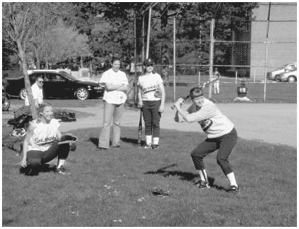 Girls' softball is a popular team sport in junior high schools and high schools. (Photograph by Robert J. Huffman. Field Mark Publications. Reproduced by permission.)