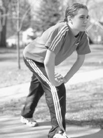 A runner demonstrates good warm-up technique. (Photograph by Robert J. Huffman. Field Mark Publications. Reproduced by permission.)
