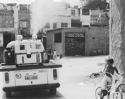 A city truck in Rio de Janeiro sprays insecticide to fight against an outbreak of dengue fever which is transmitted by mosquitos. (Reproduced by permission of AP/Wide World Photos)