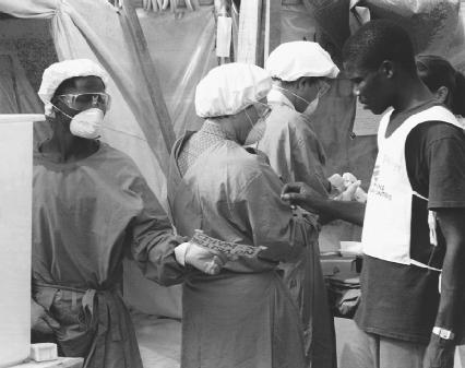 Medical workers take extra precautions at the quarantined site of an ebola outbreak in Gozon, on the Ivory Coast. (Reproduced by permission of AP/Wide World Photos)