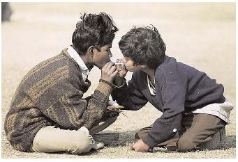 Tobacco use is a major cause of lung, lip, mouth, larynx, and throat cancer, and is a contributing cause of many other cancers. In India, where this photo was taken, the prevalence of tobacco use among students approaches 60 percent in some states. [© AFP/Corbis. Reproduced by permission.]