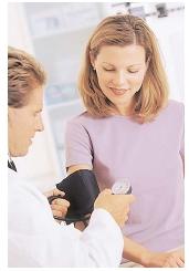 The sphygmomanometer around this woman's arm is inflated until it collapses her brachial artery, and then gradually deflated. Blood rushing into the vessel makes Korotkoff sounds that are used to time the measurements of systolic and diastolic pressure. [Photograph by Michael Keller. Corbis. Reproduced by permission.]