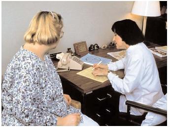 A clinical dietitian helps her patient design a nutritious weight-loss program. Such work is increasingly valuable in the United States, where three out of five adults are overweight or obese. [© 1992 SIU Biomed Comm. Custom Medical Stock Photo. Reproduced by permission.]