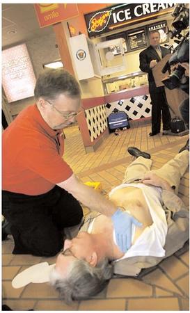 According to the American Heart Association, heart disease is the most common cause of cardiac arrest, and 95 percent of cardiac arrest patients die before they reach the hospital. That high mortality rate has prompted the placement of portable defibrillators in places such as schools, airplanes, police cars, and in this service plaza along the Pennsylvania Turnpike. [Photograph by Keith Srakocic. AP/Wide World Photos. Reproduced by permission.]