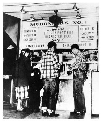 Customers line up at the very first McDonald's restaurant, which in 1954 inspired Ray A. Kroc to build a fast-food empire. Today there are more than 30,000 McDonald's restaurants worldwide. [AP/Wide World Photos. Reproduced by permission.]