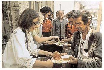 A variety of community nutrition programs receive aid from the federal government. For example, the U.S. Department of Agriculture distributes food surpluses to charitable institutions, which then provide the food to people in need. [Photograph by Vince Streano. Corbis. Reproduced by permission.]