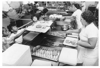 With the help of the American School Food Service Association, school cafeterias around the nation provide balanced meals, which are crucial to growing children's bodies and minds. [Photograph by Martha Tabor. Working Images Photographs.]