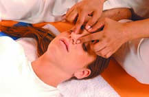 Massage along both sides of the nose with the index finger and thumb