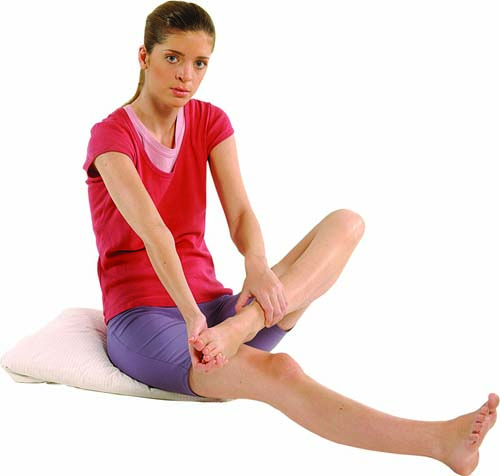 In a seated position on the floor, hold onto your left foot with both hands and move the foot in circular movements to loosen the joints