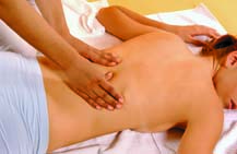 With the tips of your thumbs, massage along the spinal column, using kneading motions to relax and relieve tension built up in the back