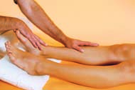 Using gentle pressure, run your palms from the feet up to the thighs of the person receiving the massage